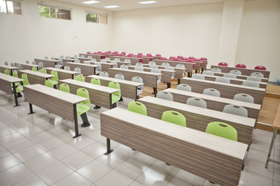auditorium room with auto-return chairs colorful and fix table