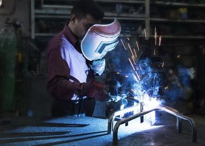 A worker is welding the steel parts together in Fleifel factory.